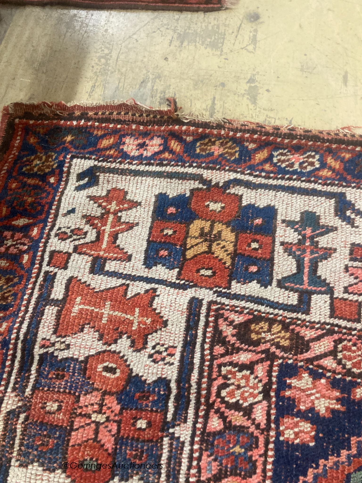 A Caucasian red ground rug, 218 x 112cm
